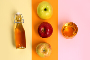 Composition with ripe apple, bottle and glass of fresh juice on color background
