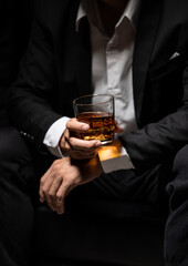 Closeup businessmen holding a glass of whiskey
