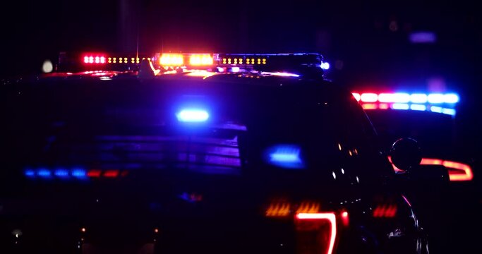 Night time view of a police unit responding to the scene of an emergency.