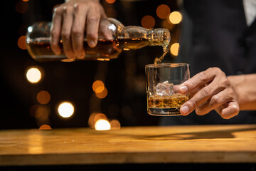 Barman pouring whiskey whiskey glass beautiful night