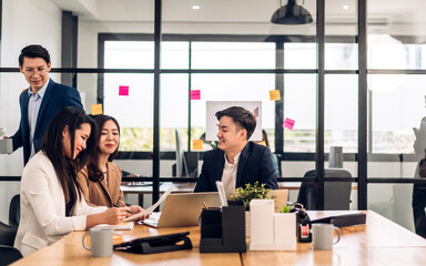 Group of asian business meeting and discussing strategy startup project analysis finance process.Success business people work plan and brainstorm marketing idea with laptop in office.Teamwork