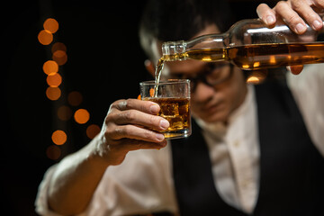 Barman pouring whiskey whiskey glass beautiful night