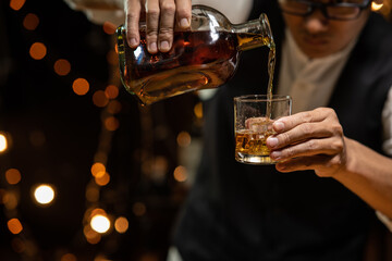 Barman pouring whiskey whiskey glass beautiful night