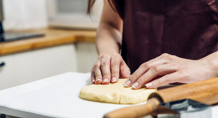 Portrait of professional woman chef having fun cooking with dough for homemade bake cookie and cake ingredient on table in kitchen