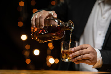 Barman pouring whiskey whiskey glass beautiful night