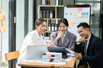 Group of asian business people working, discussing new projects together, having fun at the office.