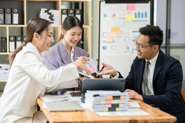 Group of asian business people working, discussing new projects together, having fun at the office.