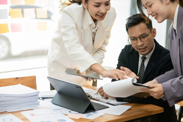 Fototapeta premium Group of asian business people working, discussing new projects together, having fun at the office.