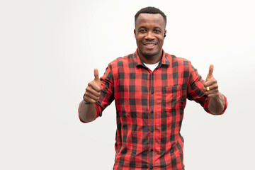 Naklejka premium Happy African American man wearing Scottish shirt smiling and thumb up, isolated on white background