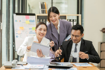 Group of asian business people working, discussing new projects together, having fun at the office.