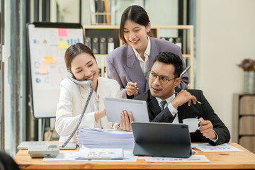 Group of asian business people working, discussing new projects together, having fun at the office.