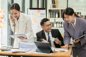 Group of asian business people working, discussing new projects together, having fun at the office.