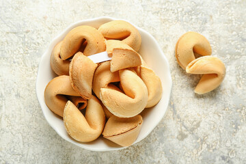 Bowl of fortune cookies on grunge background