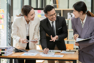 Group of asian business people working, discussing new projects together, having fun at the office.