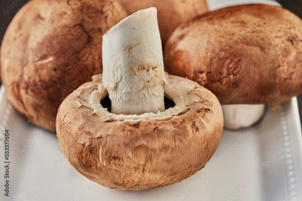 Sticker Portobello mushrooms on white plate in home kitchen