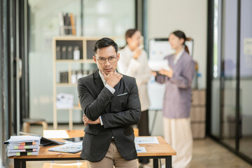 Group of asian business people working, discussing new projects together, having fun at the office.