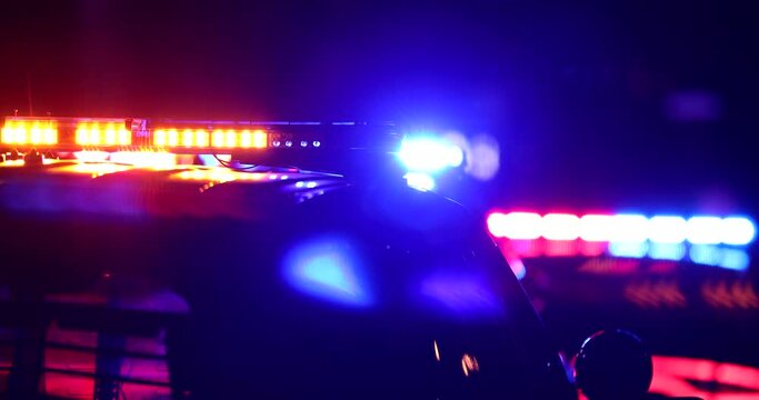 Night time detailed view of police units responding to the scene of an emergency.