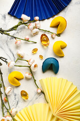 Fortune cookies with sakura and Chinese symbols on light background. New Year celebration