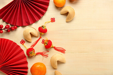 Fortune cookies, mandarins and Chinese symbols on wooden background. New Year celebration