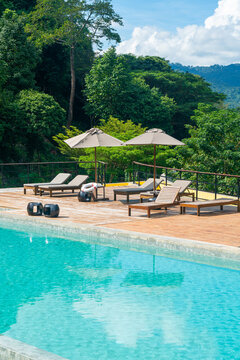 bed pool with umbrella around swimming pool