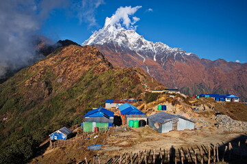 Scenic view of rocks in Annapurna massif with mountain huts on the ridge