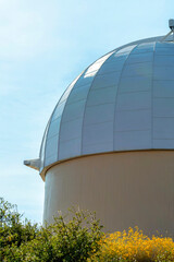 white observatory dome in shade with folliage