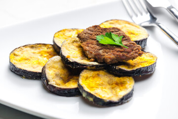 meat in breadcrumbs with grilled aubergine