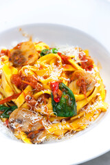 pasta tagliatelle with tomato sauce,champignon and basil leaves