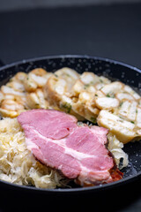 smoked meat served with sauerkraut and dumplings