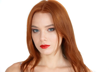 Fototapeta premium Portrait of a beautiful red-haired girl on a white background.