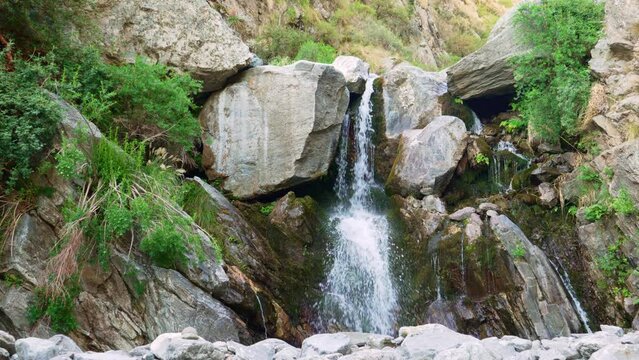 View of a beautifull waterfall with vegetation at summer. slow motion, 4k.