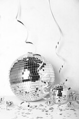 Fototapeta na wymiar Disco balls with serpentine and confetti on white background