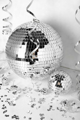 Disco balls with serpentine and confetti on white background