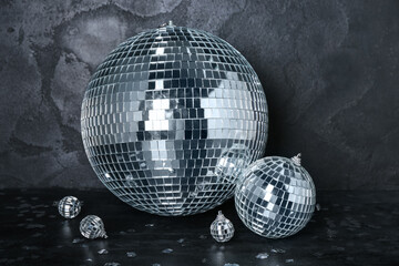Disco balls with confetti on dark background