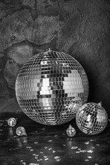 Disco balls with confetti on dark background