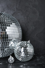 Disco balls with confetti on dark background