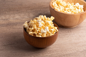 Popcorn in a wooden cup. Snacks.