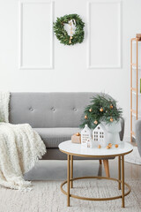 Interior of living room with house shaped candle holders and Christmas wreath