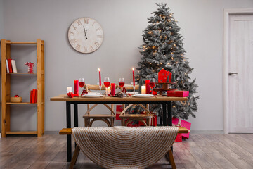 Interior of room with dining table, Christmas tree and clock