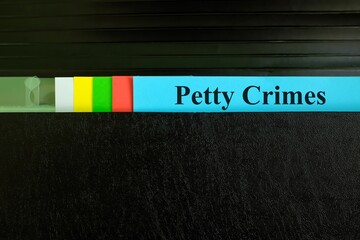 Petty crimes file record in black binder folder. Criminal law legal and justice concept.
