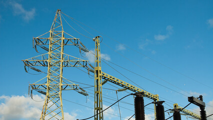 lep and electric substation on the background of blue sky and clouds, bottom view