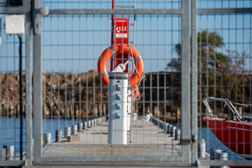 locked iron security gate to the marina in the harbor, shallow depth of field