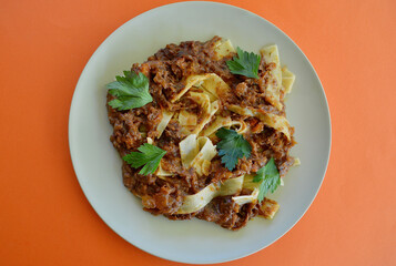 Beef ragu pappaerdelle on a plate