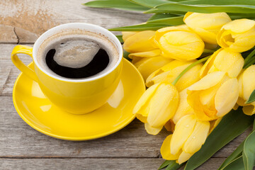 Yellow tulips and coffee cup
