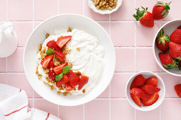 Yogurt with strawberry. Plain white greek yogurt with fresh berries and granola. Healthy food, breakfast. Top view - 553394241