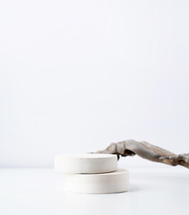 A minimalistic scene of a gypsum podium with stones on white background, for natural cosmetics