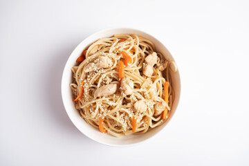 Japanese wheat noodles with chicken in a white bowl on a white background