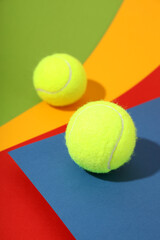Two tennis balls on different colors background