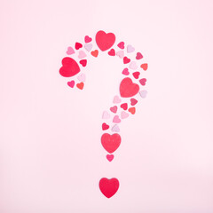 Question symbol made from hearts on a pink background. Marriage proposal symbol. The concept of...