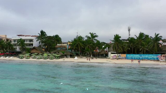 oceanfront hotels and resorts on Playa Del Carmen coastline in Mexico with gloomy overcast sky, aerial
